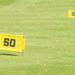 Golfer practicing distance control in golf by changing targets every shot during training.