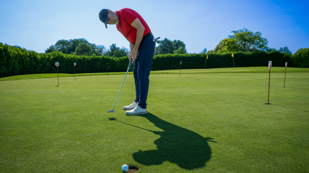 Golfer practicing putting distance control using variable training with one ball and different distances each putt.