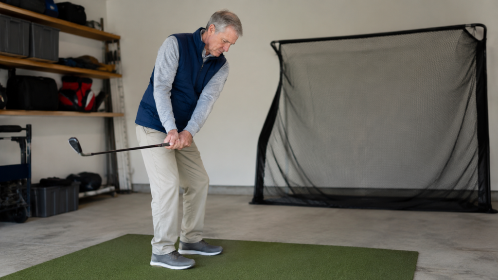 Golfer practicing a wedge motion at home to build feel and trust before range practice.