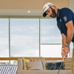 Golfer using a reverse overlap putting grip during indoor putting practice.
