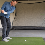 Golfer practicing stock wedge swings at home to build feel and wedge distance control.