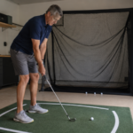 Golfer practicing a stock wedge swing drill at home to build wedge distance control.